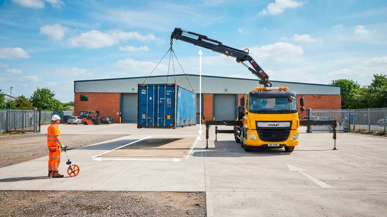 HIAB lorry delivering a shipping container with space for safe unloading